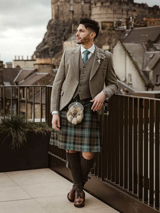 Man wearing the Black Watch Weathered kilt, paired with the Lovat Nicolson Tweed jacket