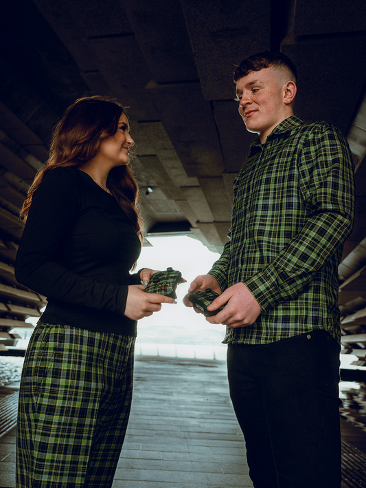 Two models wearing the GNK x Xbox tartan and holding Xbox controllers