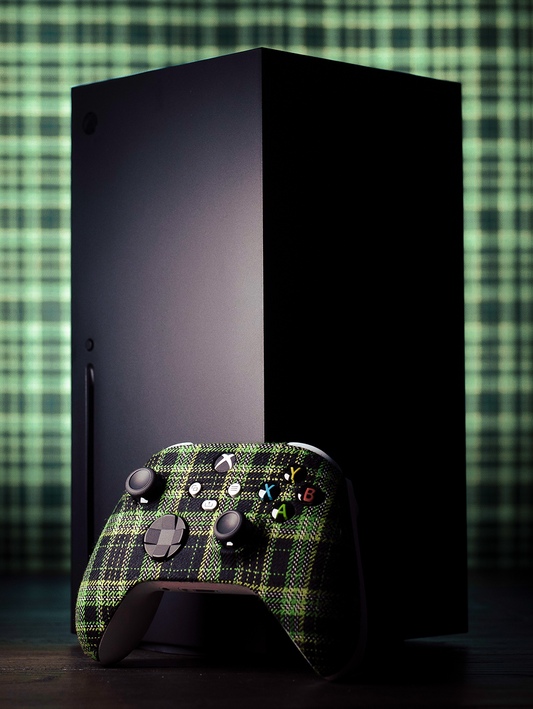 Xbox taran controller resting against an Xbox console