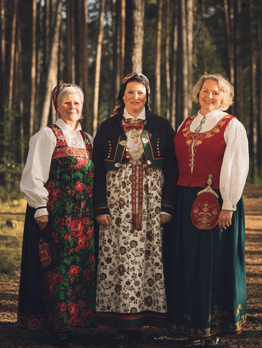 Three women wearing traditional Norwegian Bunad